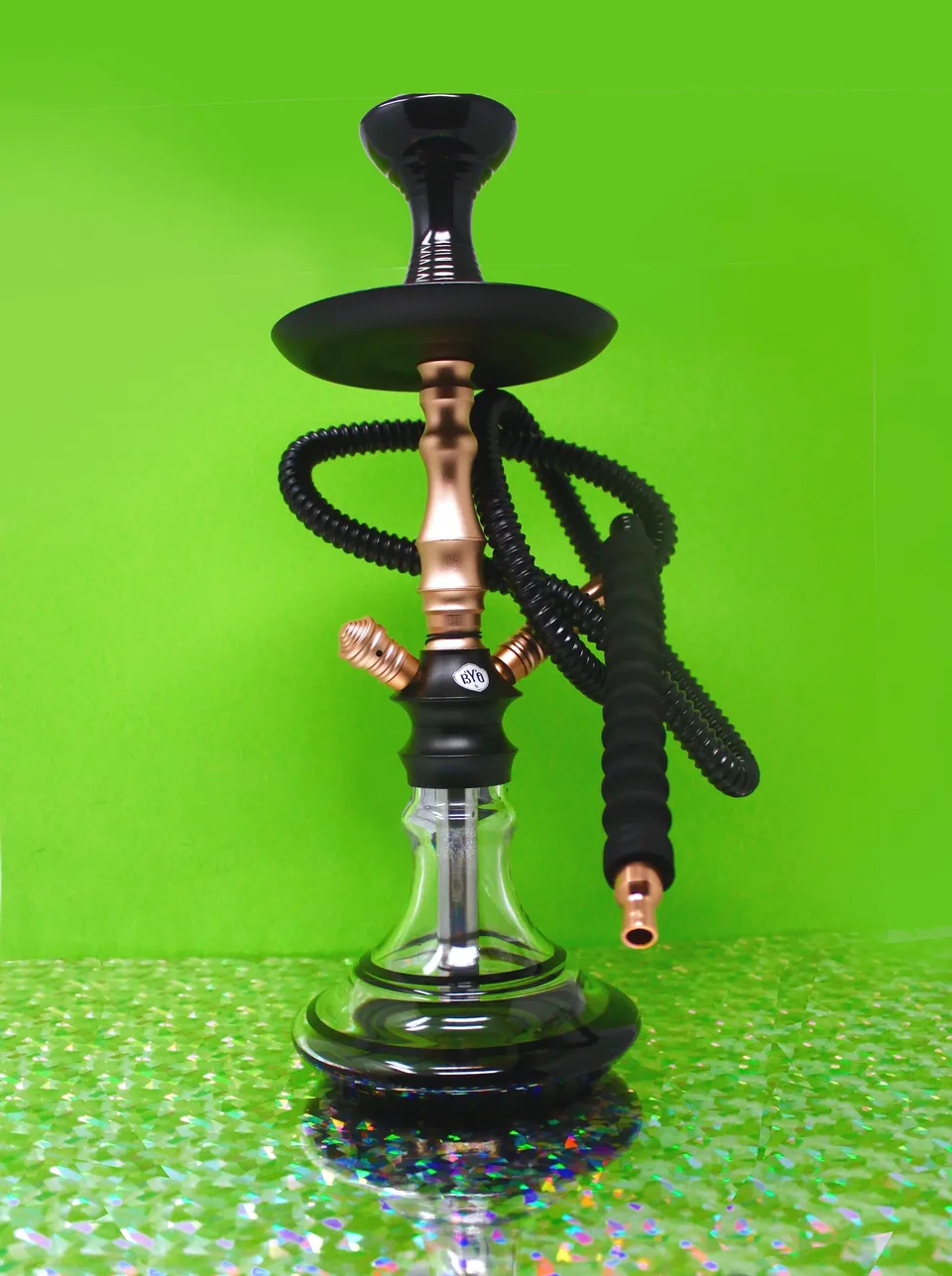 Tall black and copper hookah on a holographic surface against a lime green backdrop