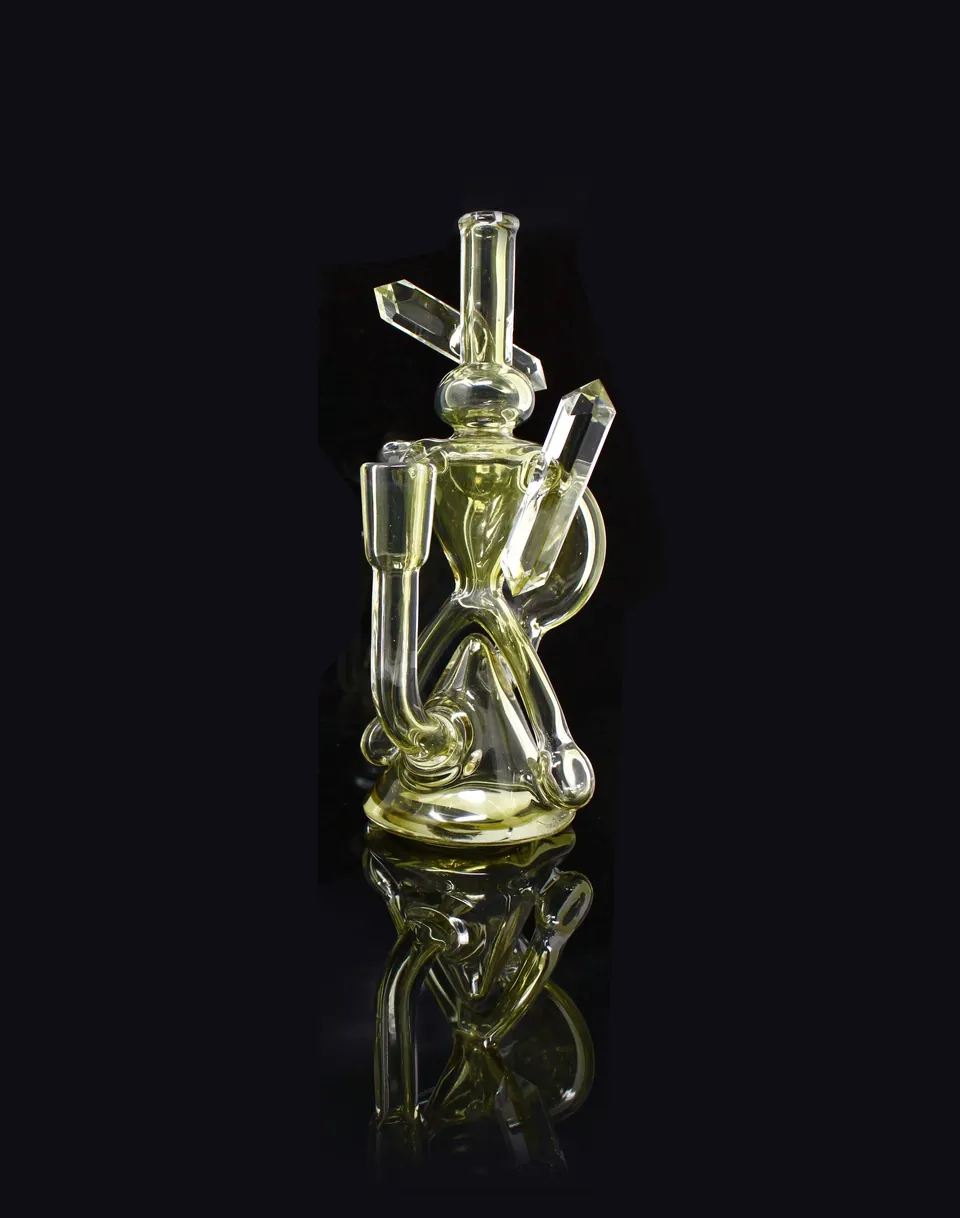 Tall clear and gold-tinted glass recycler on black