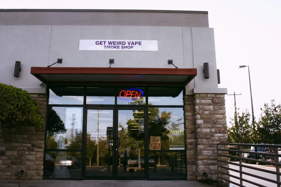 Get Weird Vape Smoke Shop storefront in a stone-front plaza on East Blackstock Road